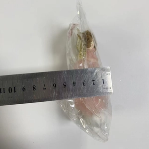 Measurement of pink mesh angel doll pendant height with a metal ruler on white background
