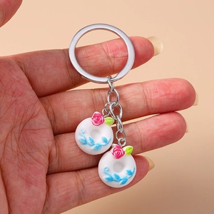 Close-up of cute cartoon food donut keychains with blue and red floral patterns