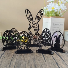 Detail view of black acrylic hollow Easter bunny and egg decorations with Happy Easter text