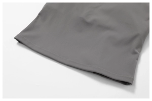 Detail of gray brushed sport vest hem featuring precise double-needle flat stitching