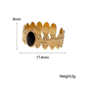Detail view of vintage 18K gold-plated ring with black oval stone and leaf pattern