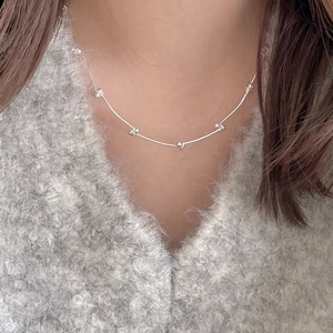 Minimalist 925 sterling silver chain necklace with small beads worn by a model