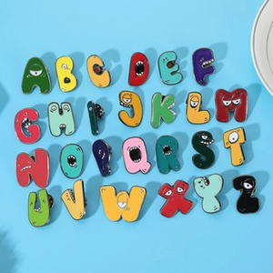 Detailed set of 26 colorful enamel alphabet monster pins on light blue background