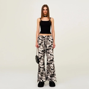 Slim fit black athletic camisole paired with camouflage cargo pants for street style
