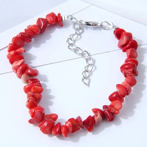 Ethnic style bracelet with irregular red stones and silver lobster clasp on white background