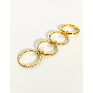 Minimalist gold-plated four-band ring set with sparkling inlaid clear gemstones