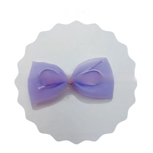 Detailed view of a purple tulle bow with pink center ribbon on a white display card