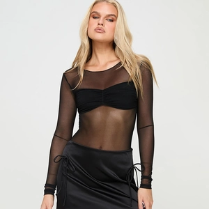Detailed close-up showing the mesh texture of the long-sleeve top and the satin skirt fabric