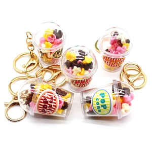 Five mini popcorn cup keychains with transparent bodies and golden metal rings