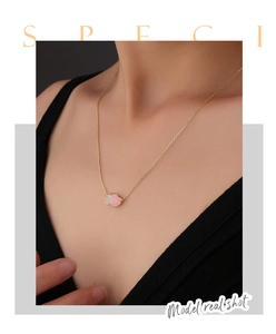 Close-up of S925 silver necklace featuring double heart pendant with pink gemstone and crystals