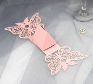 Macro detail of pink laser-cut butterfly candy box made of premium pearlescent paper