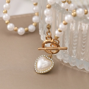 Elegant heart pearl necklace with rhinestone border and gold OT toggle clasp detail