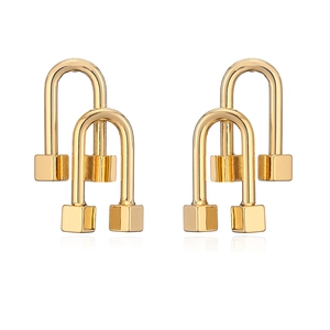 Macro detail of gold-plated geometric earrings with double arches and square pendants