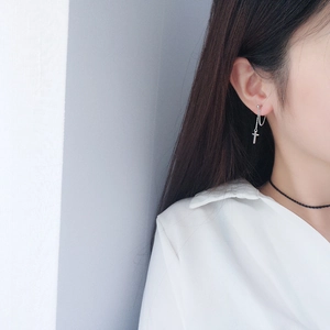Fashionable silver cross dangle earrings with elegant long chain fringe on female model