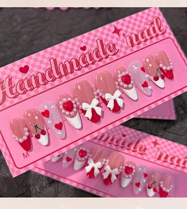 Detail of handmade sweet style press-on nails with 3D bows and red heart designs