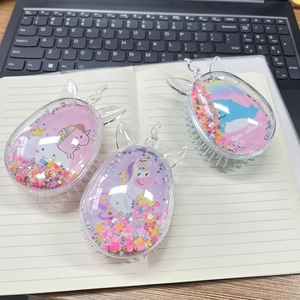 Detail of glitter liquid quicksand hairbrushes with cute cartoon unicorn and whale designs