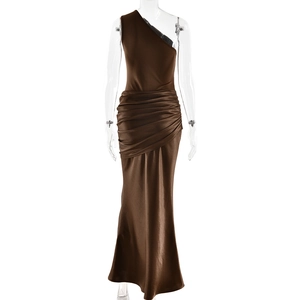 Detail of a brown one-shoulder satin dress featuring high-gloss pleats and mermaid silhouette