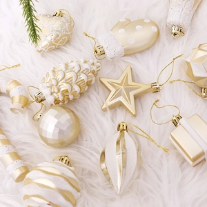 Golden and white assorted plastic Christmas tree ornaments set on a white plush background