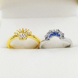 Detailed view of celestial sun and moon rings with sparkling blue and white zircon stones