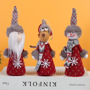 Three plush Christmas dolls featuring Santa, Reindeer, and Snowman on a warm background