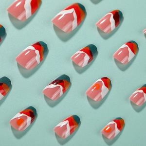 Short round press-on nails with sunset abstract pattern in pink and orange shades