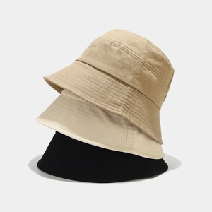 Vertical stack of classic cotton bucket hats in khaki, cream, and black with reinforced stitching