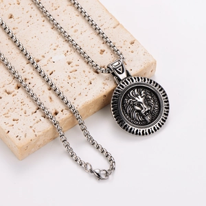 Vintage stainless steel necklace featuring a round lion head pendant on a textured stone
