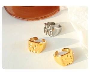 Detailed view of square open rings with unique hammered texture in gold and silver finish