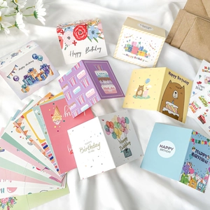 Collection variée de cartes d'anniversaire colorées avec enveloppes et autocollants.