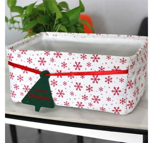Close-up of white Oxford cloth Christmas storage basket with red snowflakes and green tree tag