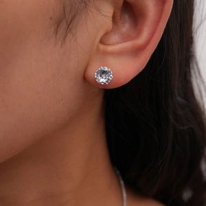 Close-up of a classic silver claw-set round brilliant-cut cubic zirconia stud earring