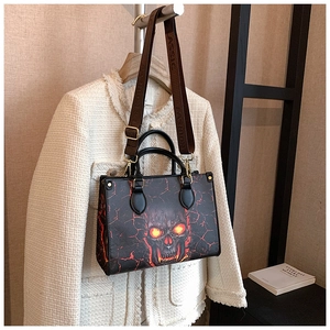 Detail of skull print tote bag with lava crackle pattern and branded wide strap