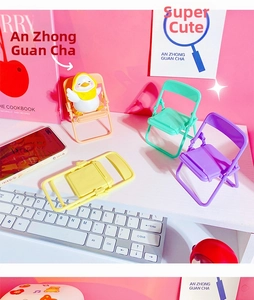 Macro view of colorful mini folding chair stands in pink, green, purple and yellow