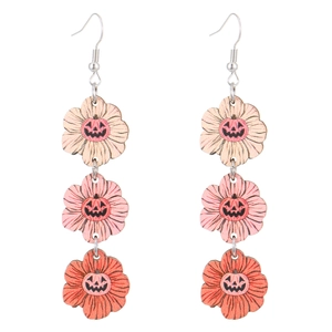 Detail view of tiered wooden Halloween earrings with floral pumpkin jack-o-lantern patterns