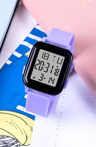 Macro shot of purple square digital sports watch with silicone strap and functional display