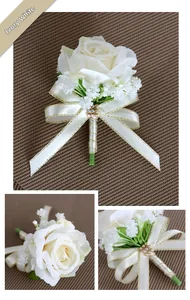 Detail view of ivory rose boutonniere with satin ribbon and golden trim for weddings