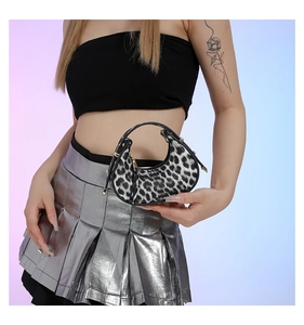 Detail of leopard print crescent bag with silver hardware and metal zipper closure