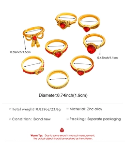Detailed view of a 7-piece gold alloy ring set with red heart gems and dimensions