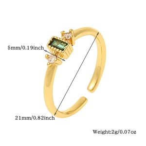 Detailed side view of adjustable gold ring with green rectangle stone and clear side stones