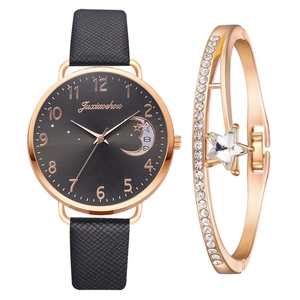 Detail of rose gold moon dial watch with black strap and matching star crystal bracelet