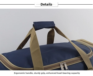 Detail of ergonomic handles with velcro grip on large blue waterproof travel bag