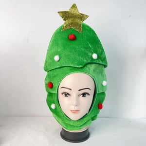 Close-up of plush green Christmas tree hat with red pom-poms and a golden star topper