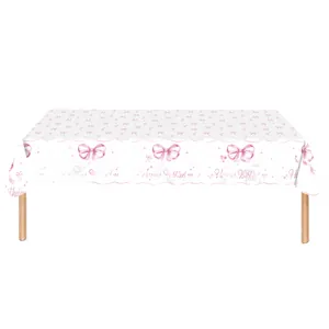 Close-up of pink ribbon bow patterns and Happy Birthday script on white disposable tablecloth