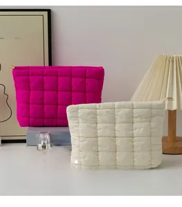 Close-up of quilted nylon pouches with vibrant pink and cream colors and zipper closure
