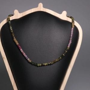 2mm natural tourmaline beaded necklace with gradient rainbow gemstones on a bust display