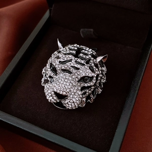 Macro shot of vintage tiger head brooch with white cubic zirconia and black enamel detail