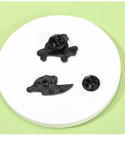 Close-up of black metal pins backside and rubber clutch attachments on white display pad