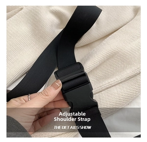 Close-up of adjustable black nylon shoulder strap with a sturdy plastic buckle detail