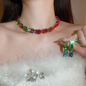 Detail of colorful rectangular gemstone necklace and earrings set worn by a model