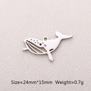 Macro detail of hollow whale tail pendant showing 24mm x 15mm size and 0.7g weight
